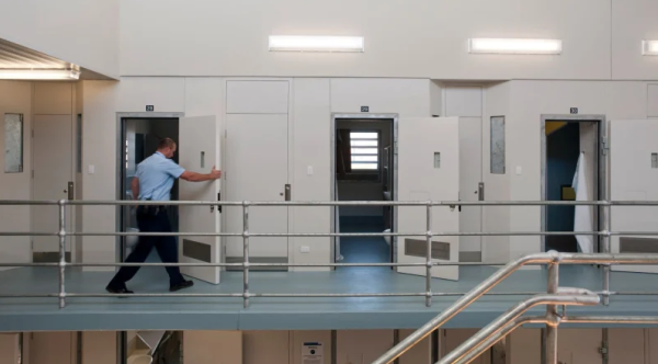 Image of corrections officer opening doors to empty cells at Dame Phyllis Frost Centre
