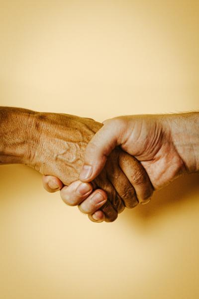 Two hands holding. Photo by Ave Calvar on Unsplash