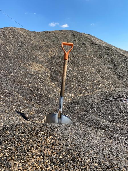A shovel standing up in a pile of gravel. Photo by gokhan polat on Unsplash