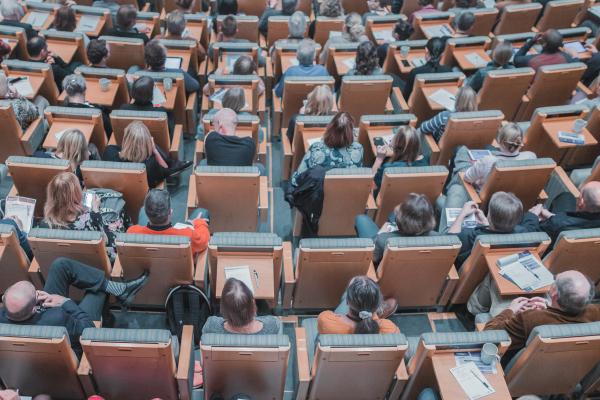 A university lecture hall filled with students. Photo by Mikael Kristenson on Unsplash