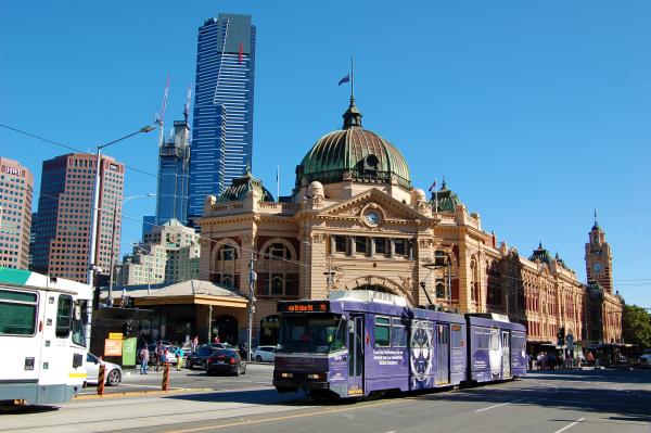 An image of Flinders Street Station with trams crossing out front. Photo by Paul Macallan on Unsplash